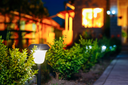 A solar-powered light illuminating a pathway.