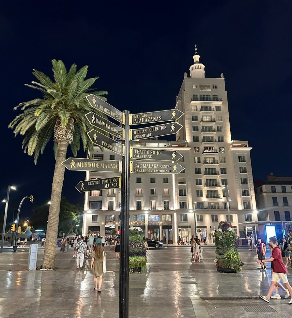 A plaza in the Costa del Sol showing directions for museums, shopping, and more.